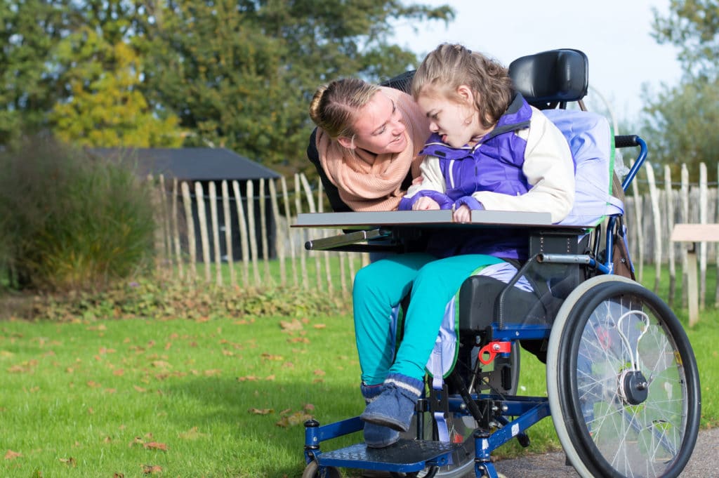 Disabled child in a wheelchair outdoors